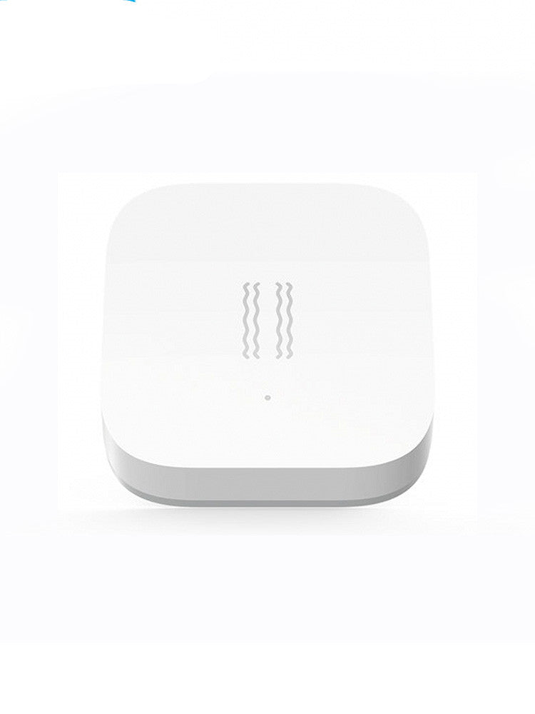Smart Vibration Sensor Alarm placed on an opened book, showcasing its compact and sleek design.