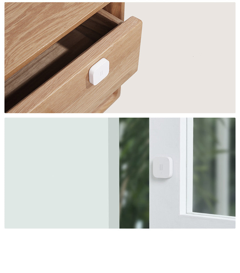 Smart Vibration Sensor Alarm placed on an opened book, showcasing its compact and sleek design.