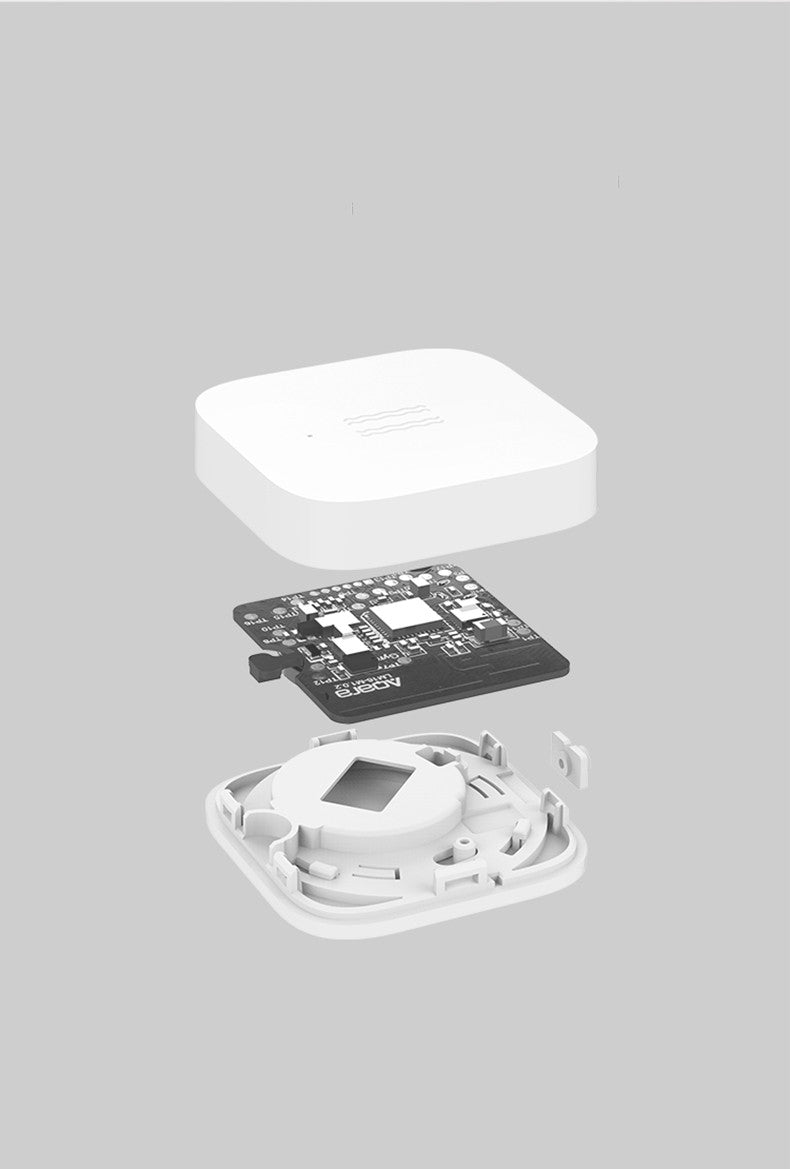 Smart Vibration Sensor Alarm placed on an opened book, showcasing its compact and sleek design.